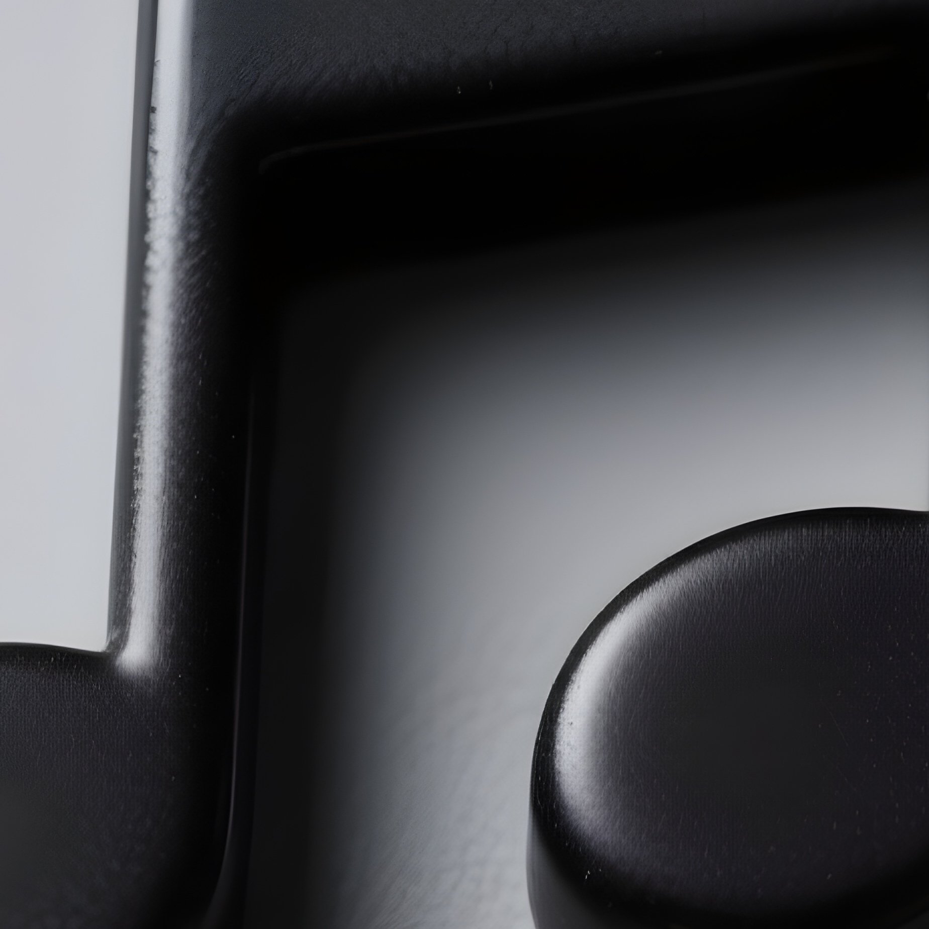 A Button Shaped Like A Music Note Black Plastic No Label - Full Resolution Quality Preview