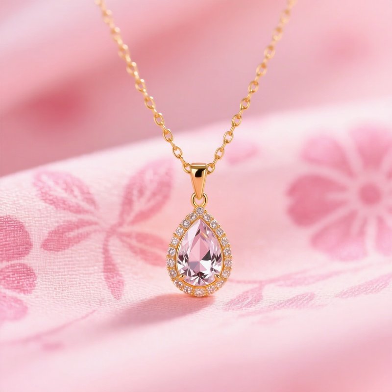 A Gold Necklace With A Teardrop Shaped Gemstone Pendant Jewelry
