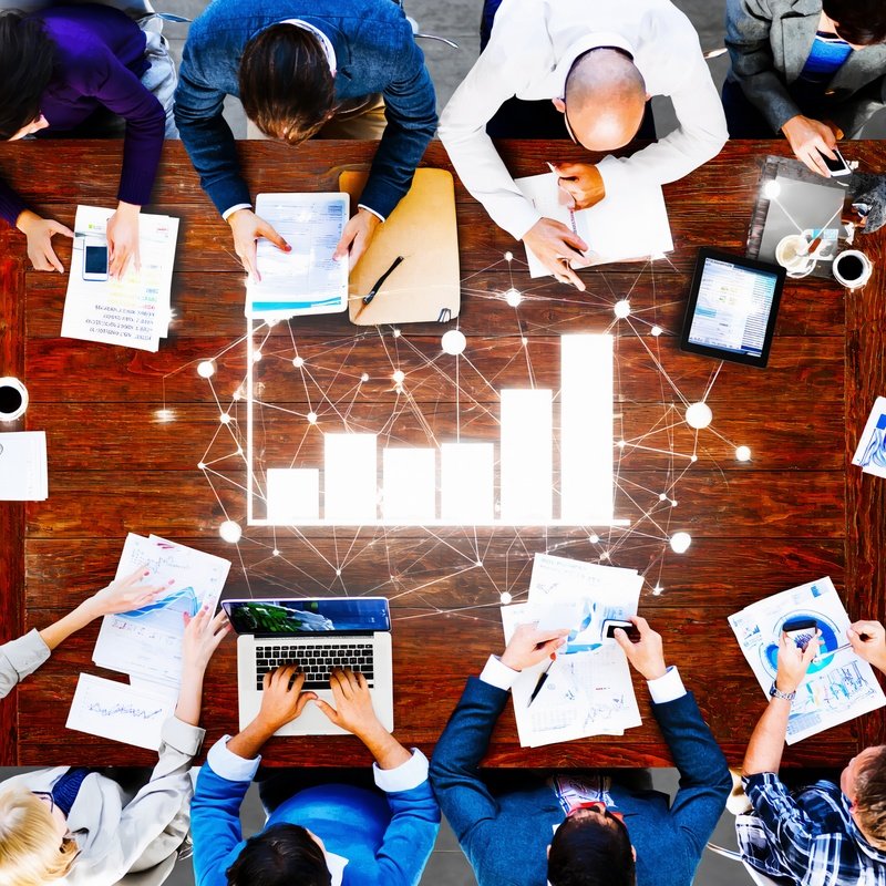 A Group Of People Working Together At A Table Collaboration