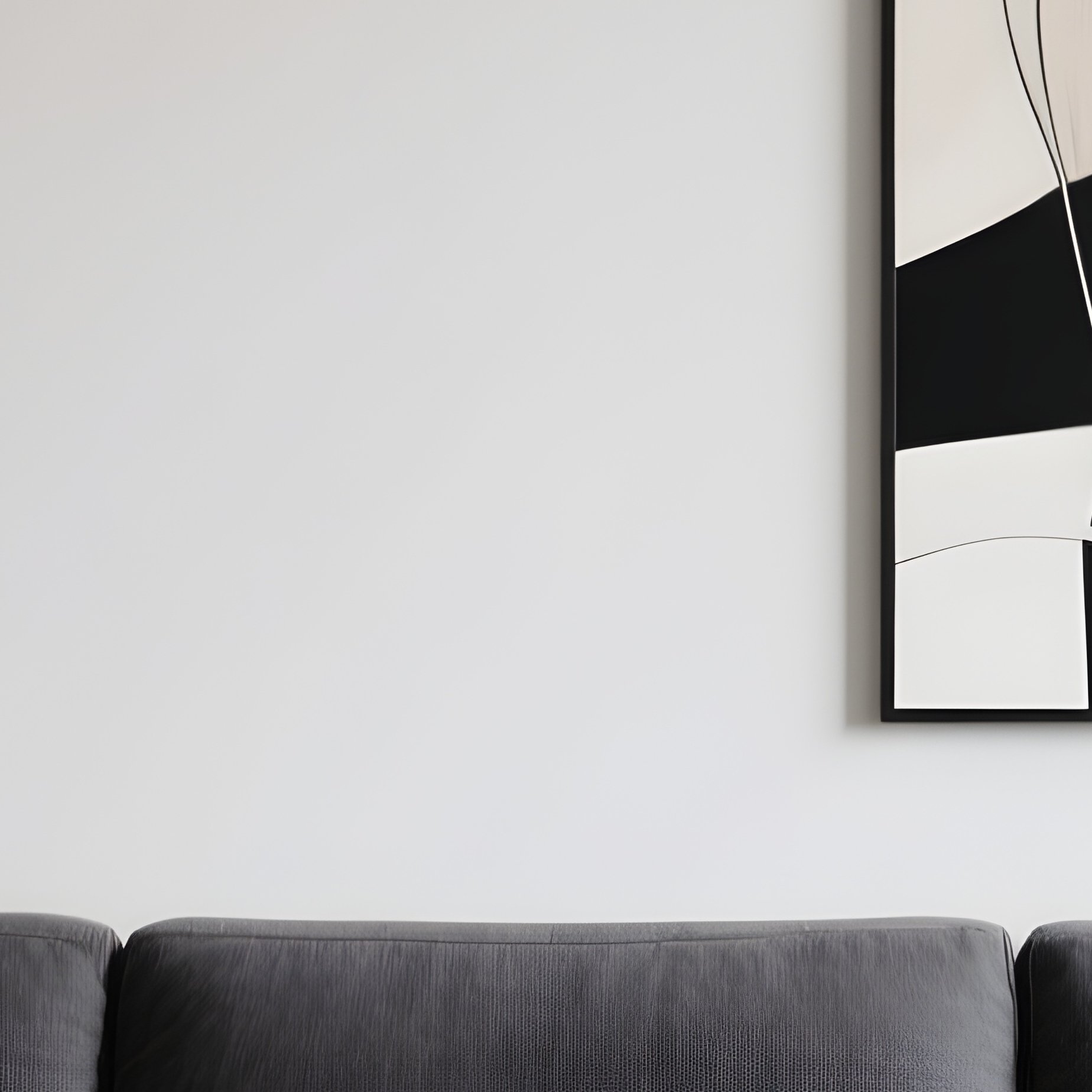 A Modern Lounge With A Low, Wide Sectional Sofa In Charcoal Fabric, Complemented By A Blackened Steel Coffee Table And Abstract Artwork - Full Resolution Quality Preview