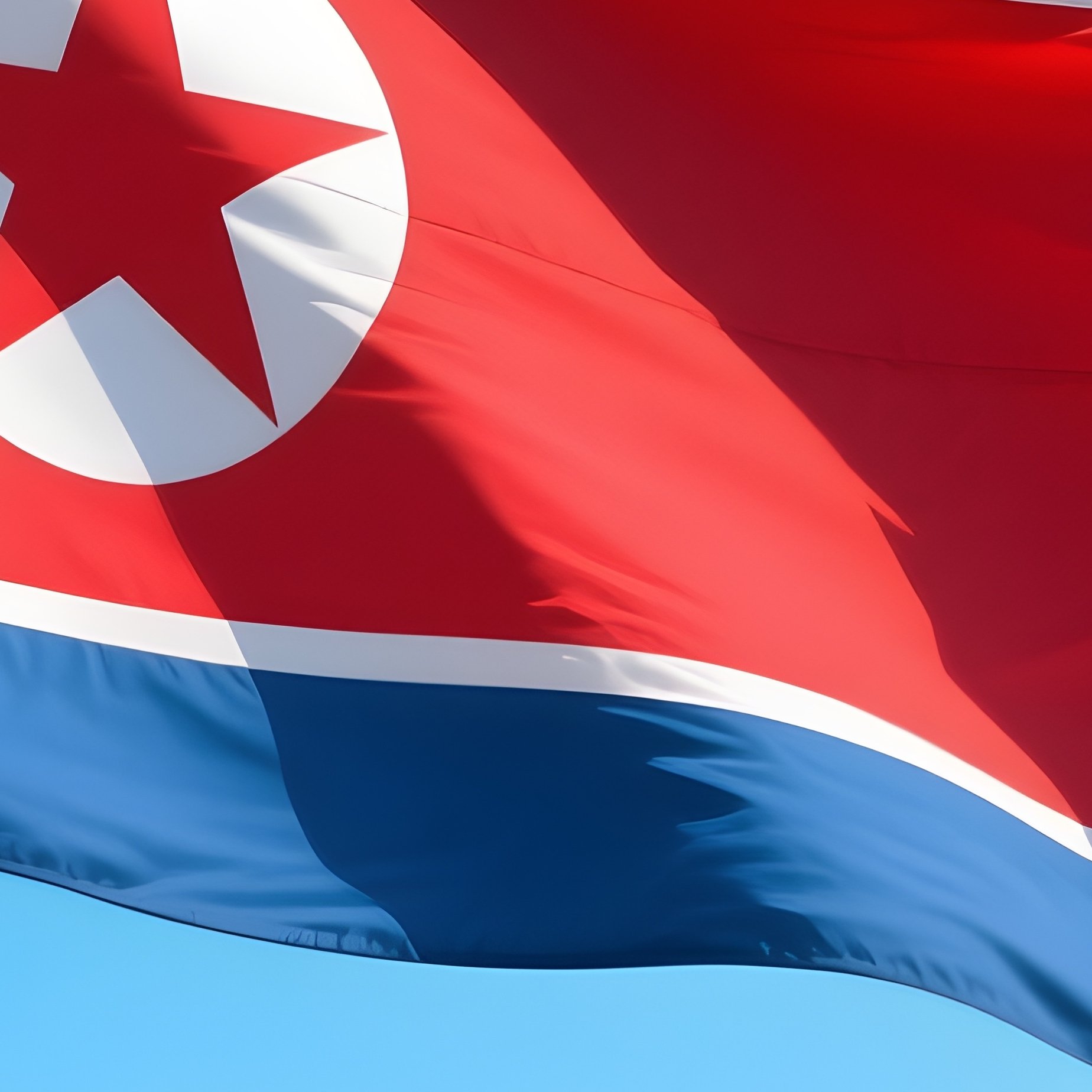 A Photorealistic North Korean Flag Waving Near A Calm Riverside Under Bright Blue Sky. - Full Resolution Quality Preview