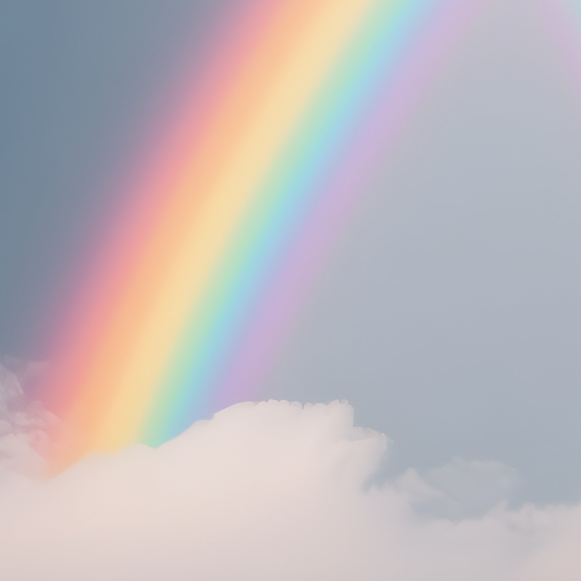 A Rainbow Appearing Through The Clouds Over A Snowy Ridge - Full Resolution Quality Preview