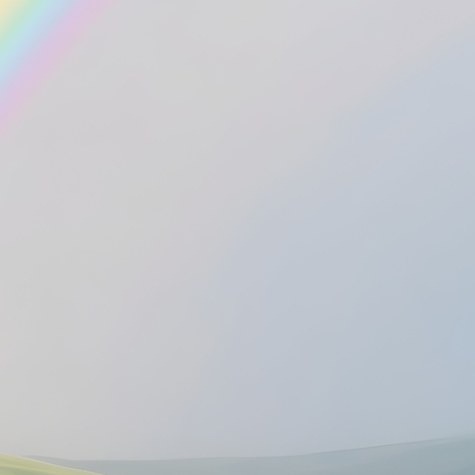 A Rainbow Stretching Above Green Rolling Hills - Full Resolution Quality Preview