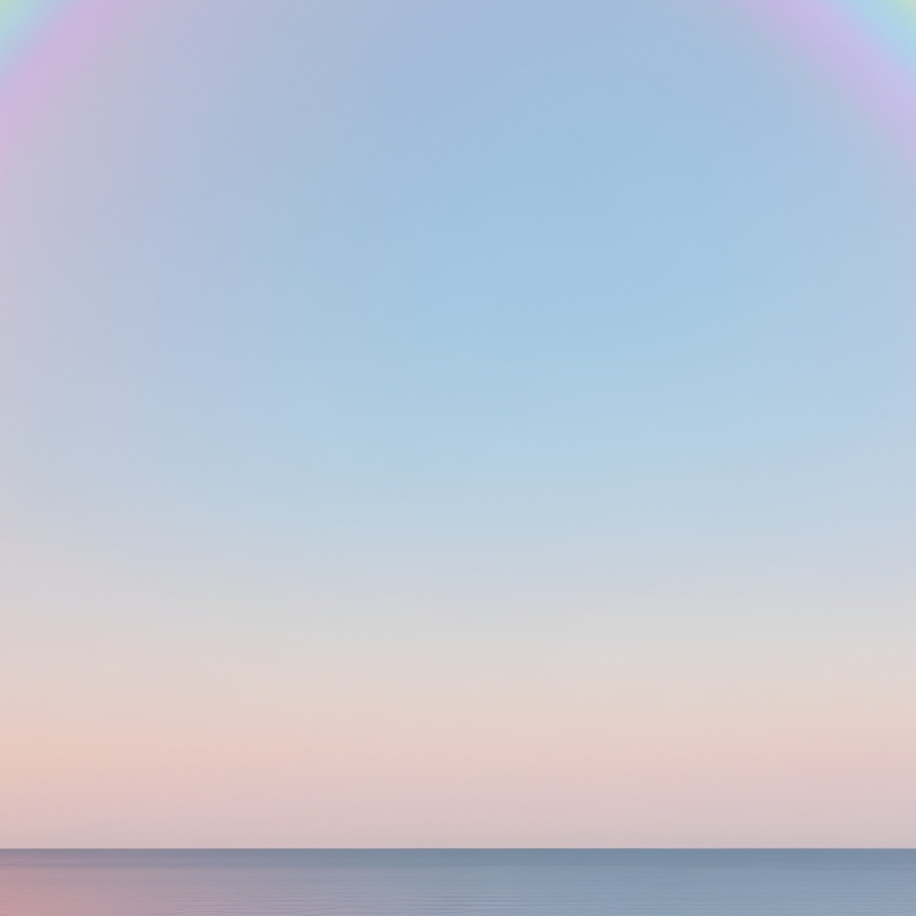 A Shimmering Rainbow Touching The Horizon Of A Calm Sea - Full Resolution Quality Preview