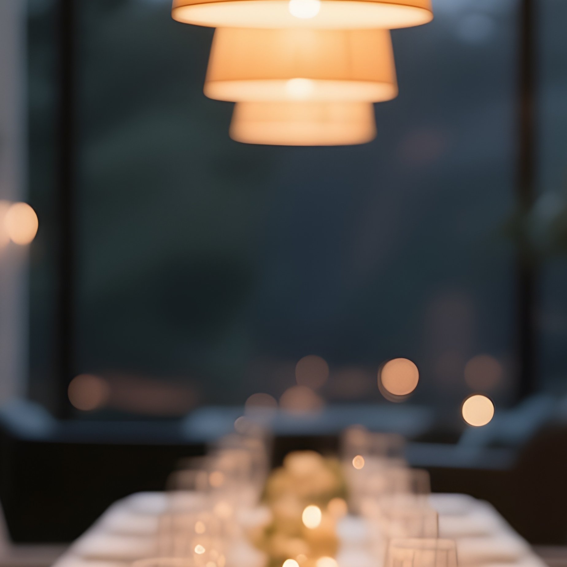 A Sophisticated Dining Area With A Long Table Set For An Evening Gathering, Illuminated By Warm Pendant Lights - Full Resolution Quality Preview