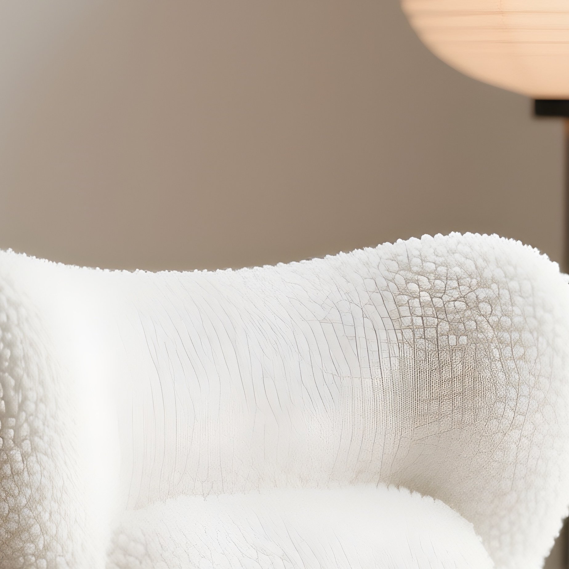 A Trendy, Sculptural White Bouclé Accent Chair Placed In A Japandi Style Living Room, Paired With A Small Solid Wood Side Table And Bathed In Soft, Diffused Lighting From A Paper Lantern. - Full Resolution Quality Preview