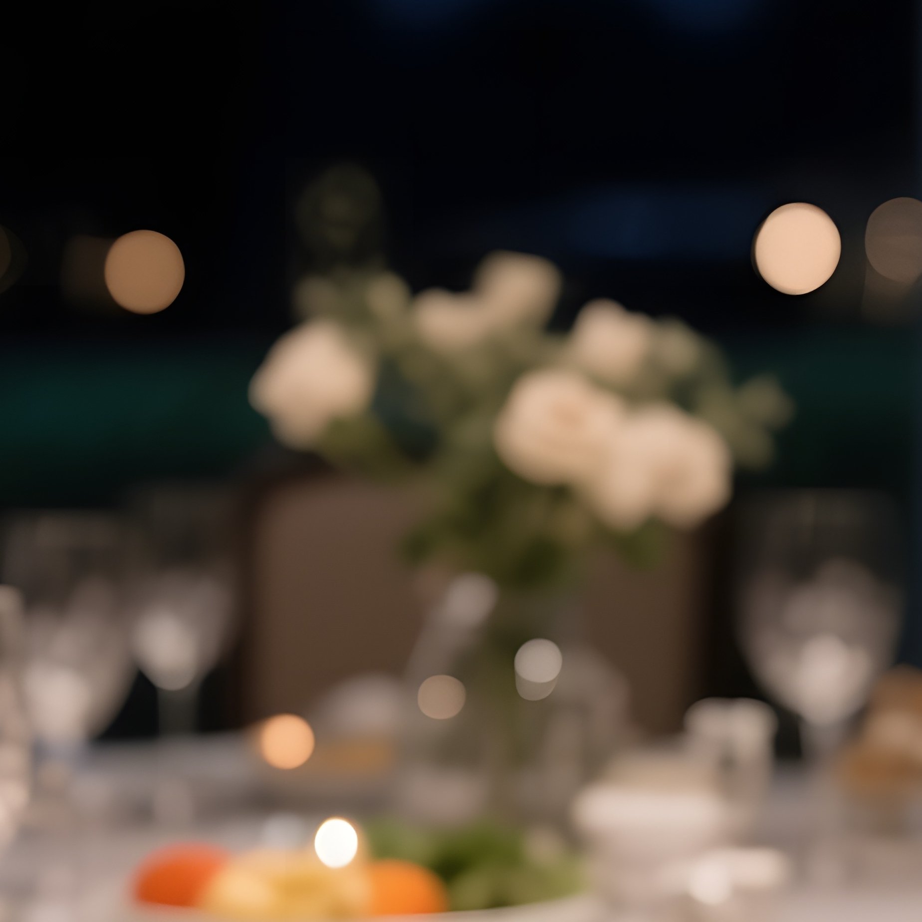 An Elegant Dining Room Table At Night, Illuminated By Chandelier Glow, Featuring A Polished Silver - Full Resolution Quality Preview